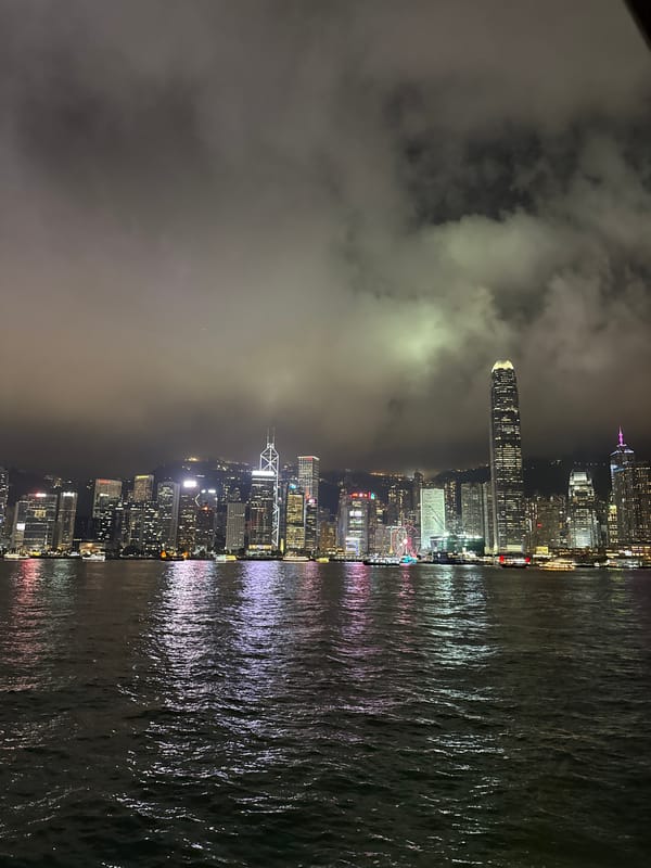 Hong Kong skyline viewed from water amid fog