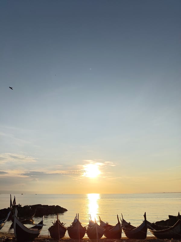 Sunrise observed over Lhokseumawe beach with traditional fishing boats