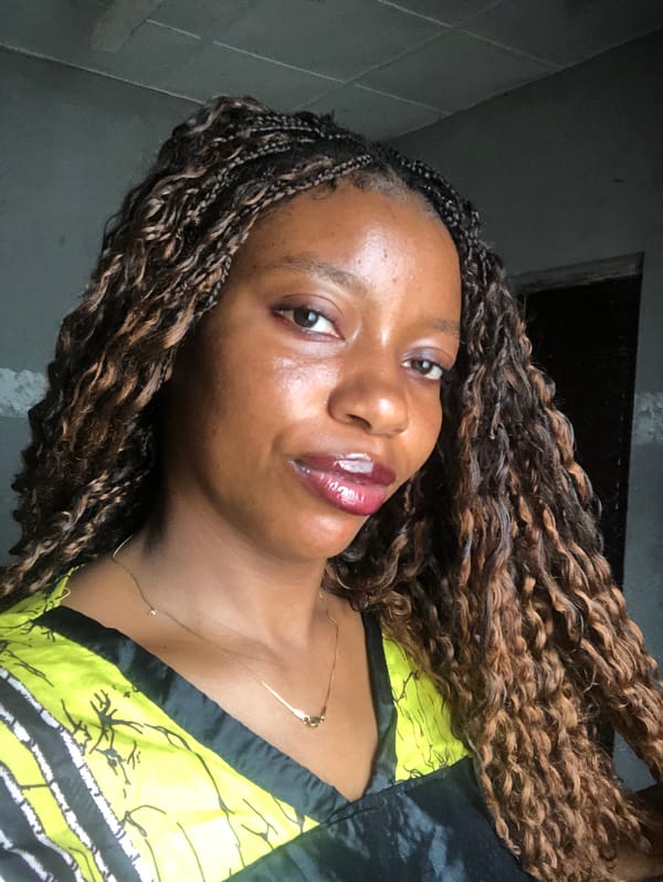 Woman takes selfies indoors in Nigeria during morning photo session