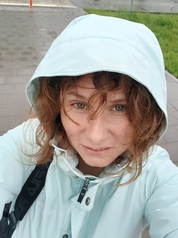 Woman and child share umbrella during rainy day in Yekaterinburg