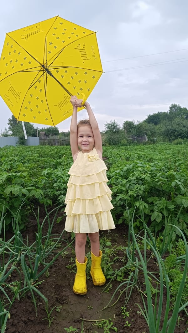 Rainy summer day in a Karsha garden with two small kids