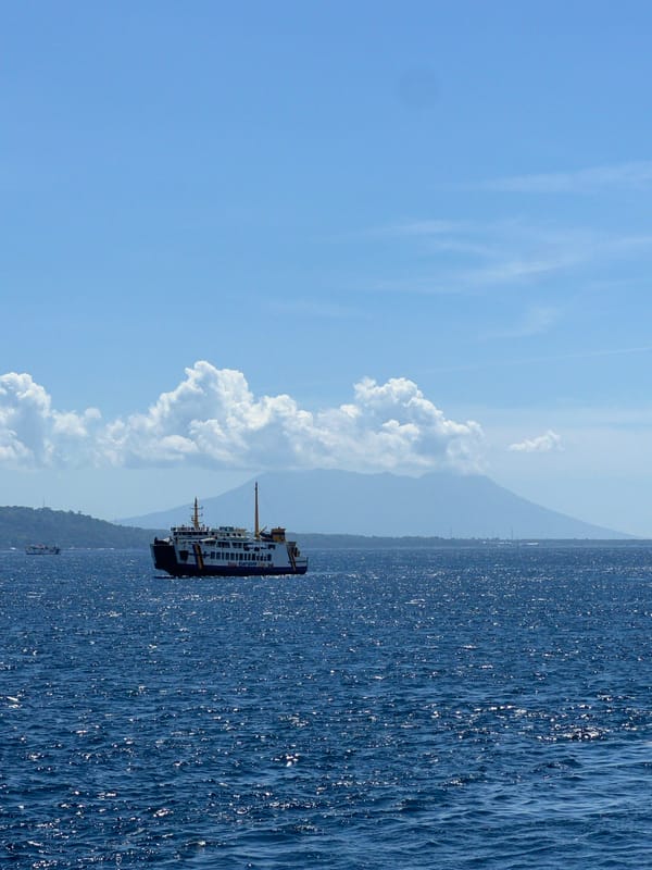 Ferry passengers document morning journey off Melaya, Indonesia coast