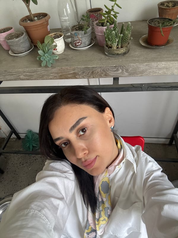 Woman photographed in plant-filled interior space in Tbilisi