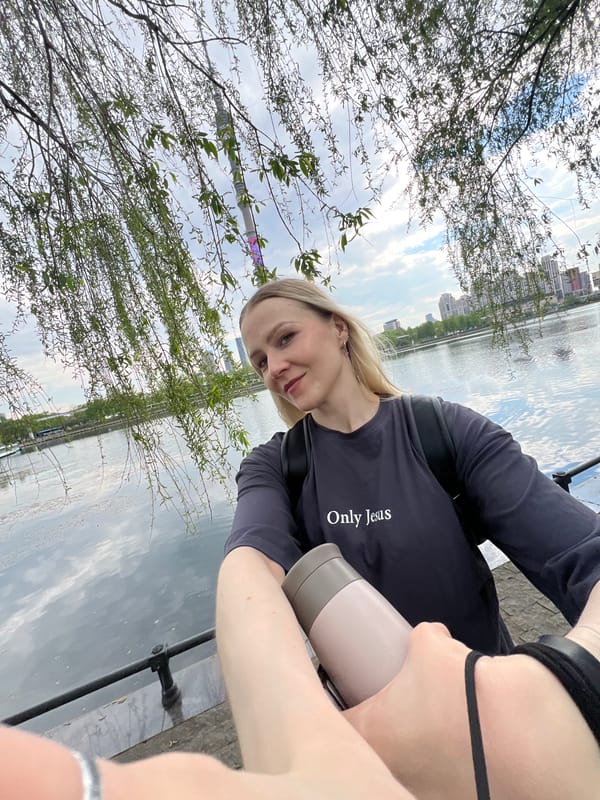 Woman with religious shirt observed near Orthodox church with birds