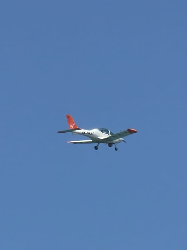 Aircraft and sailboat spotted under clear skies in Tel Aviv