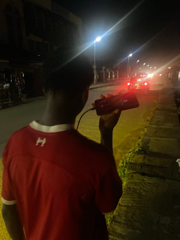 Evening phone call and nighttime street walk observed in Lagos