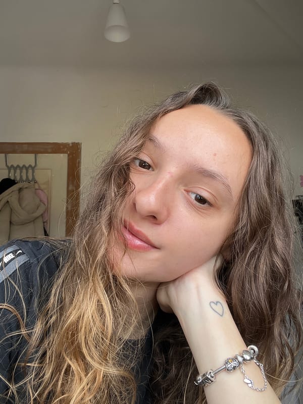 Young woman takes selfie in Saarbrücken showing heart tattoo