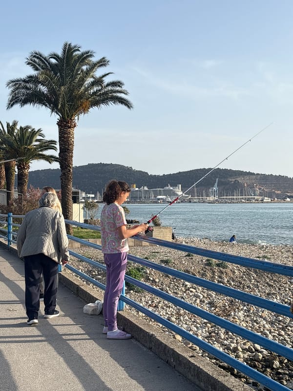 Child fishes from pier in Bar, Montenegro coastal area