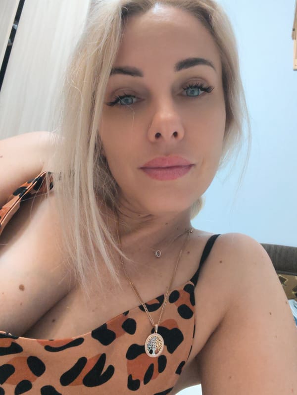 Woman takes selfies with sleeping white cat in Sevastopol
