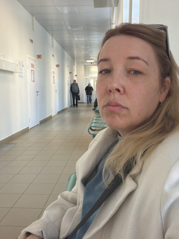 Woman takes selfies in Russian apartment building hallway