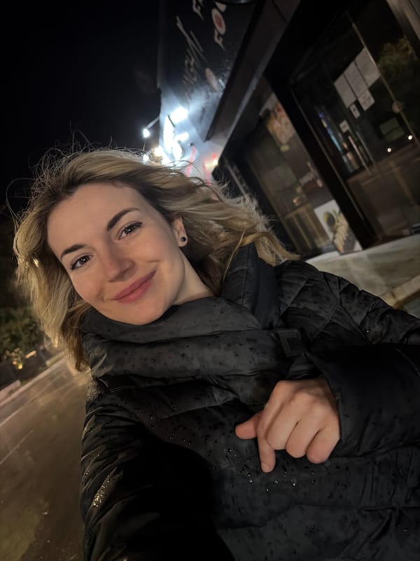 Woman films herself on rainy Budva street at night