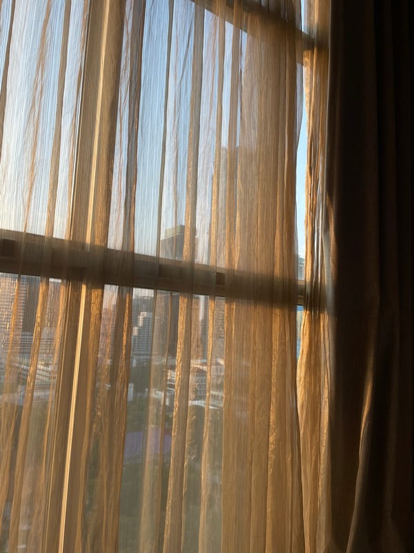 Morning sunlight filters through Bangkok window blinds