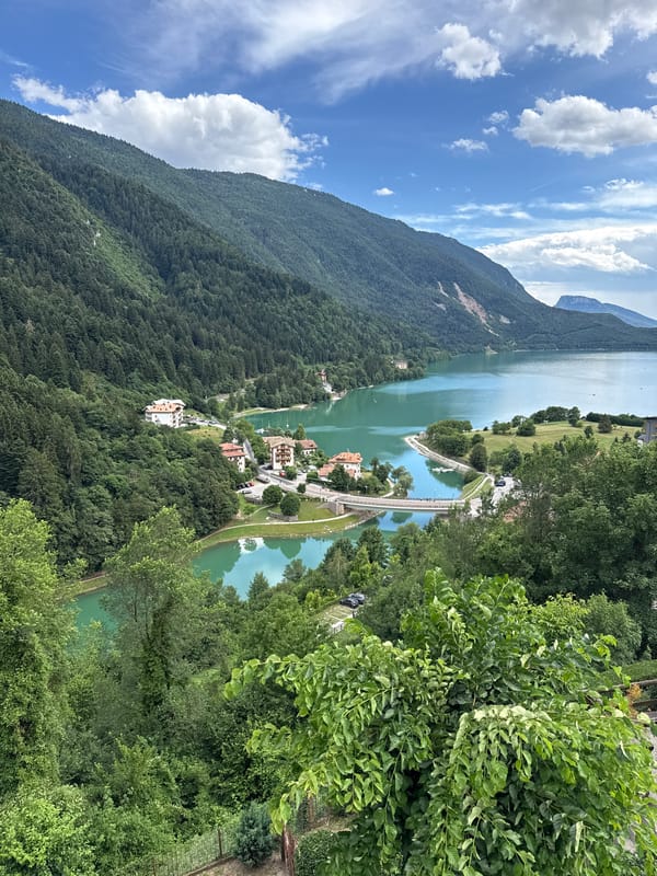 Paragliding over Molveno's turquoise lake and Alpine peaks