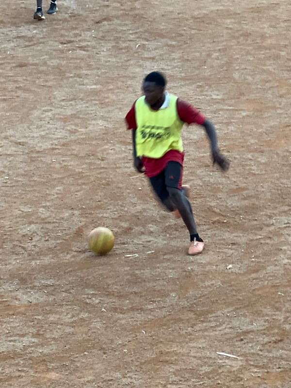 Pickup soccer on a dirt field in Jos, Nigeria