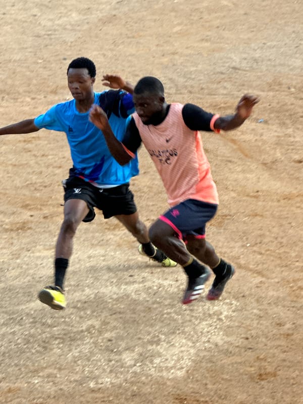 Pickup soccer on a rocky dirt field in Jos, Nigeria