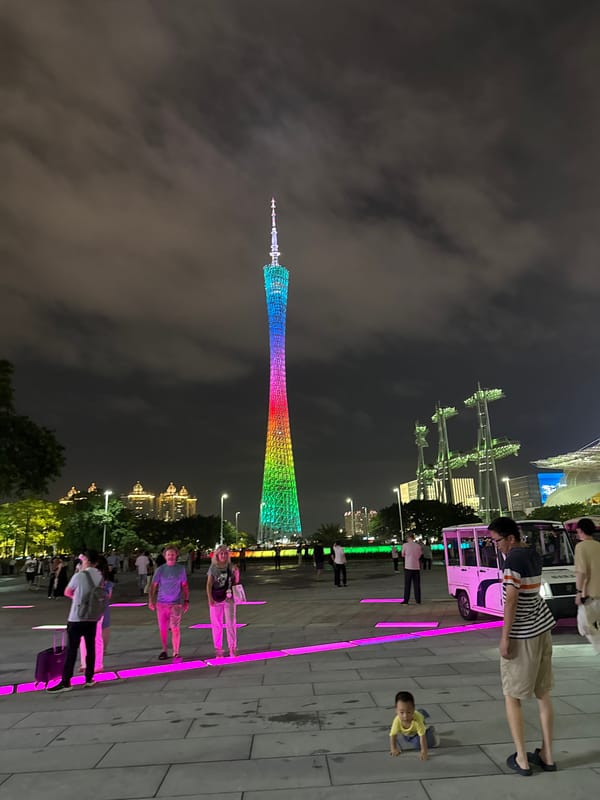 Canton Tower lights up a crowded Guangzhou plaza at night