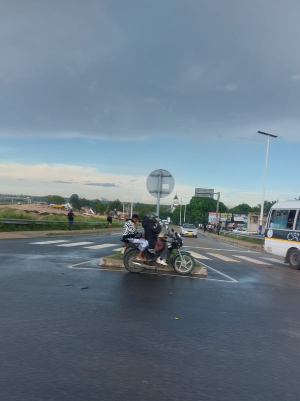 Motorcycle traffic observed on wet Dar es-Salaam street