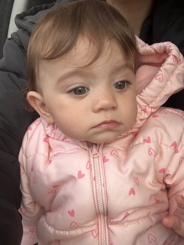 Baby in pink heart jacket photographed in Elena, Bulgaria