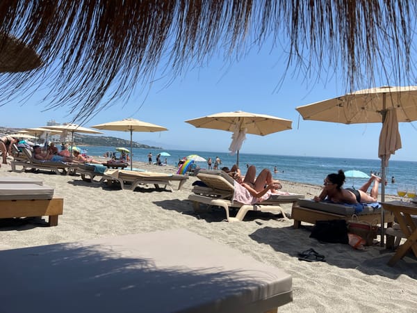 Sunny beach day at San Roque's busy shoreline