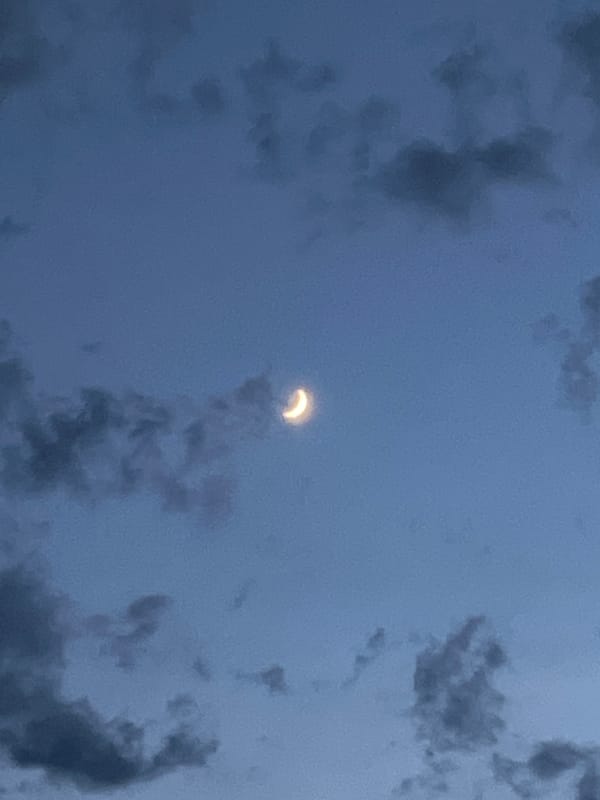 Crescent shape in cloudy Sochi sky, Moon or eclipse