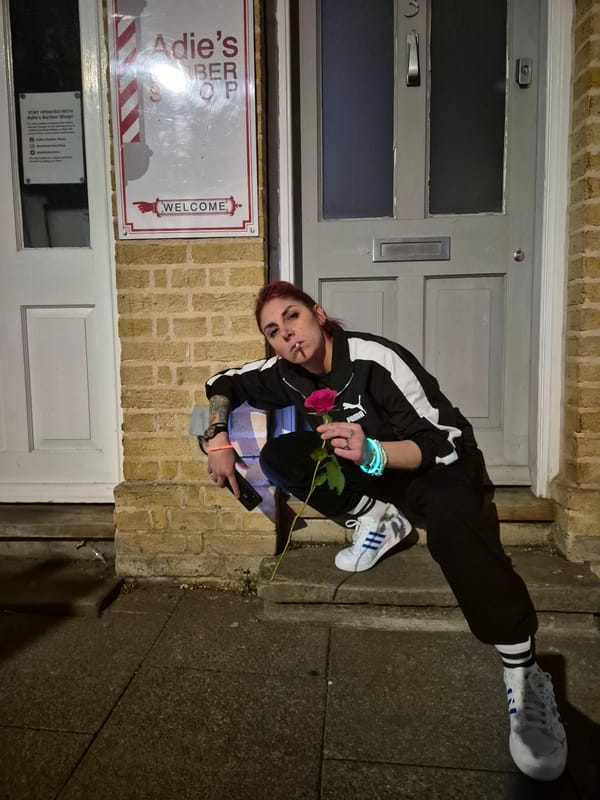 Person crouched near building entrance in West Suffolk