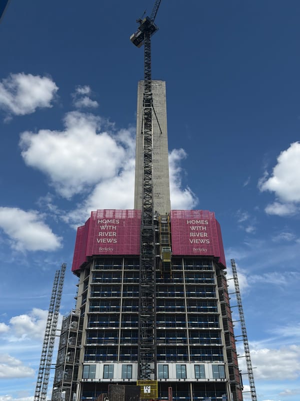 High-rise construction project observed in London with pink scaffolding