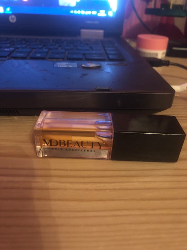 Laptop and skincare product photographed together in Velingrad