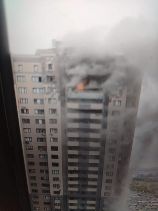 Major fire engulfs high-rise and industrial structures amid heavy smoke