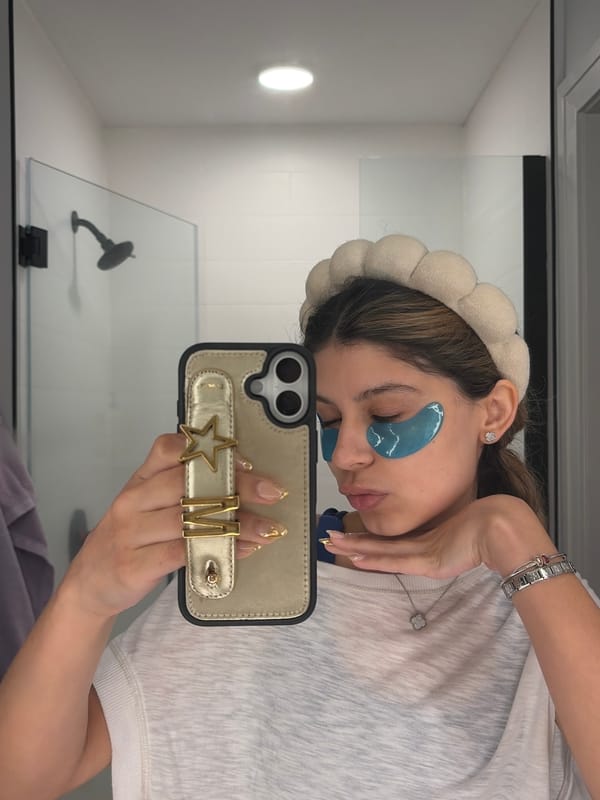 Woman takes selfie with skincare patches in Austin bathroom