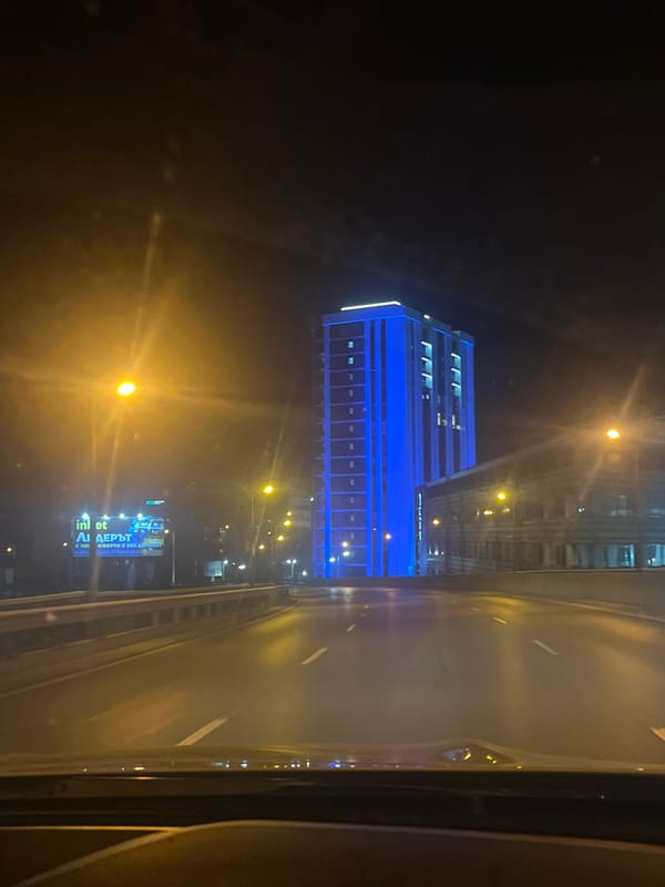 Nighttime drive through illuminated Sofia streets captured on video