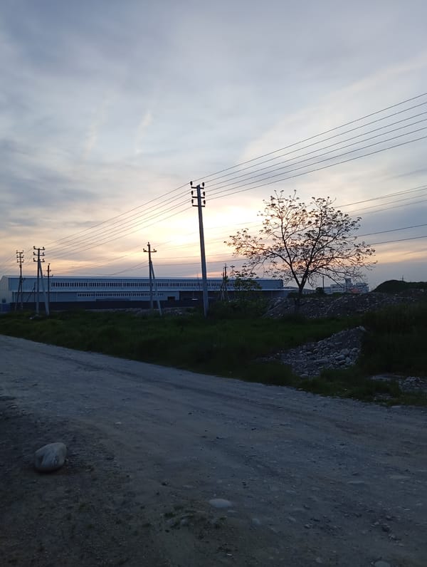 Dusk landscape with curved dirt road documented in Baksan