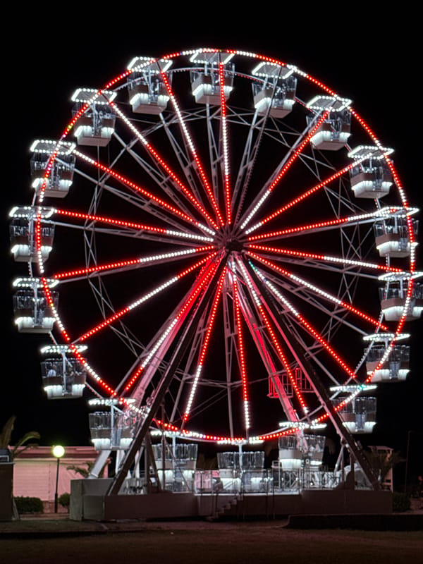 Evening at illuminated Ferris wheel attraction in Budva Montenegro