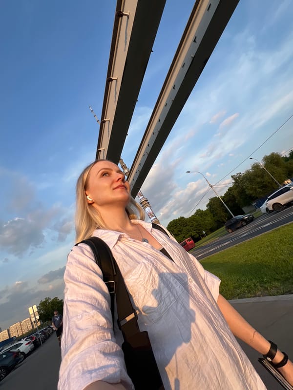 Woman pauses on Khimki bridge overlooking Moscow Canal