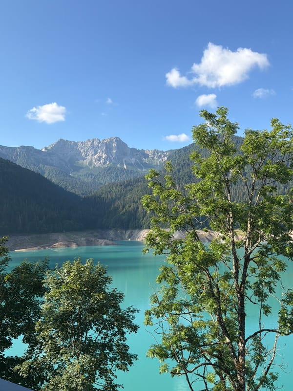 Low-water alpine reservoir in the Carnic Alps on a summer morning