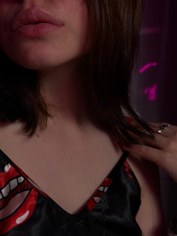 Vanity mirror selfies and makeup in a pink-lit room