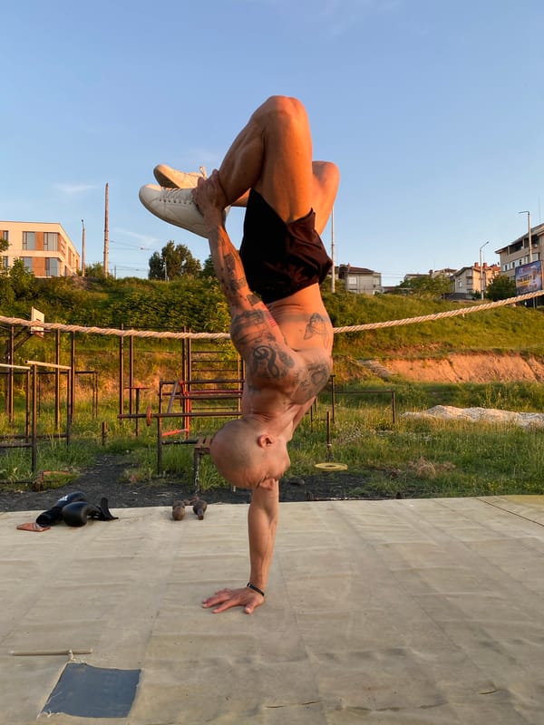 Tattooed athlete trains boxing and handstands in Pleven