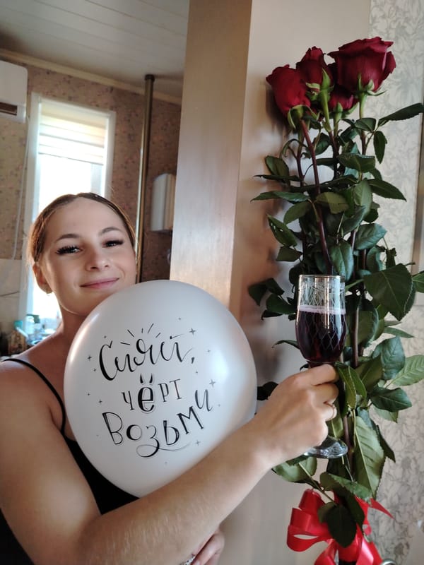 Indoor celebration with balloon, wine, roses in Рассвет, Russia