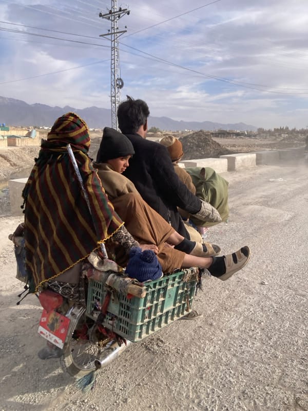 Five people ride overloaded motorcycle on dusty Quetta road