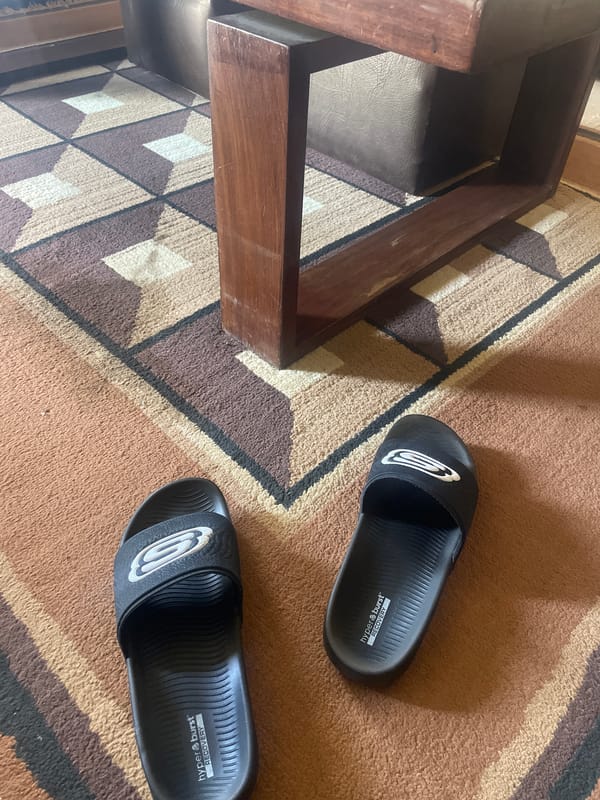 Indoor scene captured in Gura Top showing stool and sandals