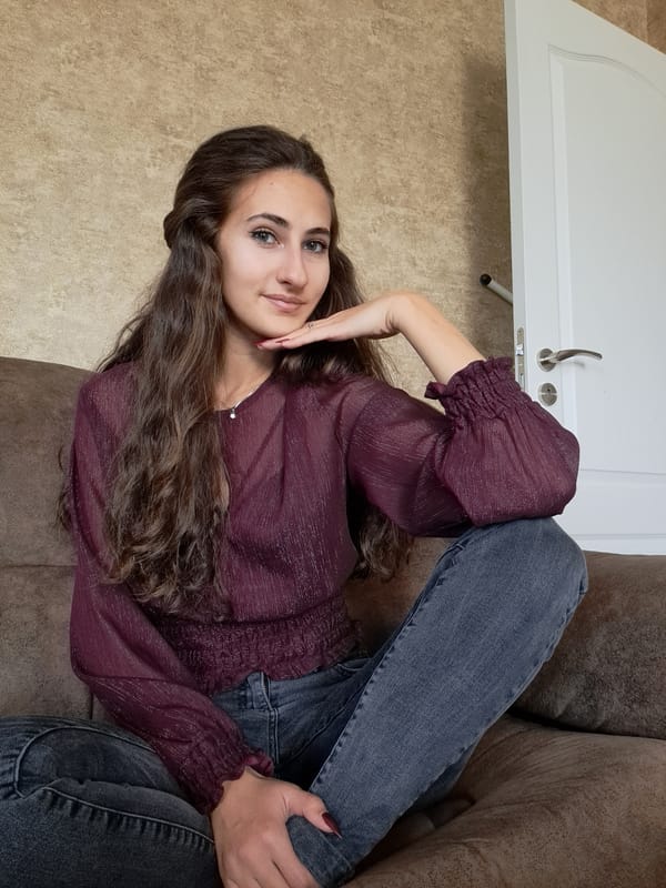 Woman poses for photos on couch in Negovan