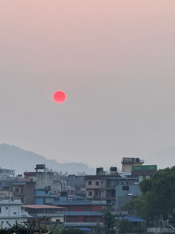 Red sun observed through hazy skies over Pokhara, Nepal