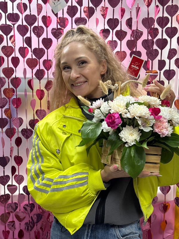 Woman displays flowers, wears floral headdress in Perm spring celebration