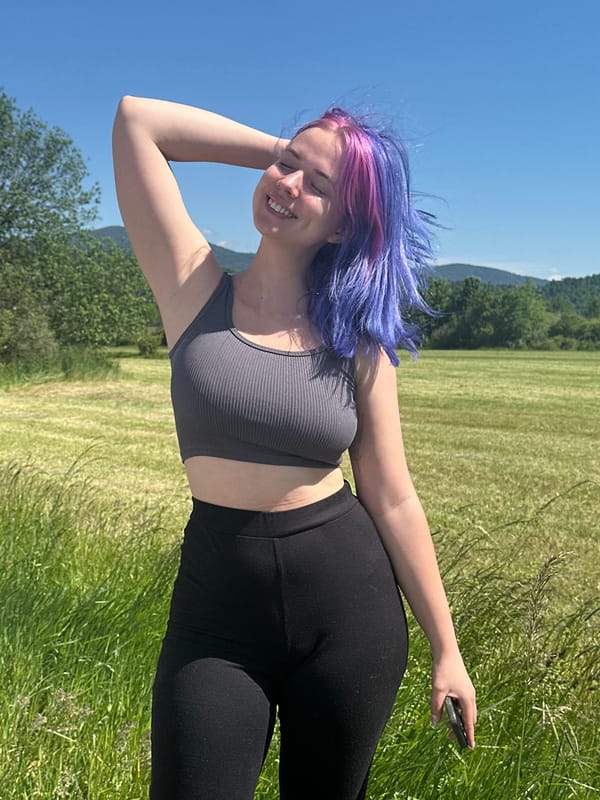 Woman with colorful hair photographed in Postojna field