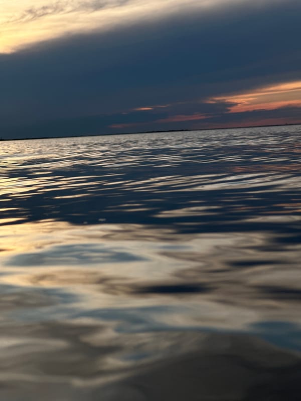 Dusk settles over a Kokshetau lake, water reflecting the fading sky