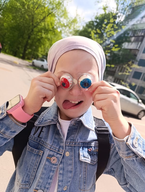 Urban moments: girl with novelty glasses, garden flowers, foraging pigeons