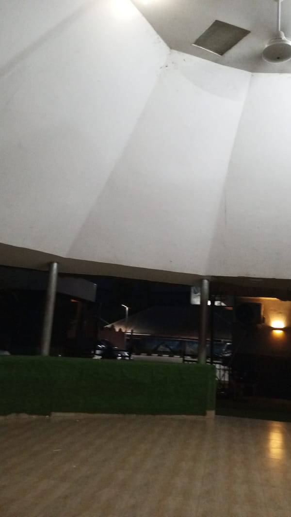 Man dining at outdoor restaurant patio in Adankolo Nigeria