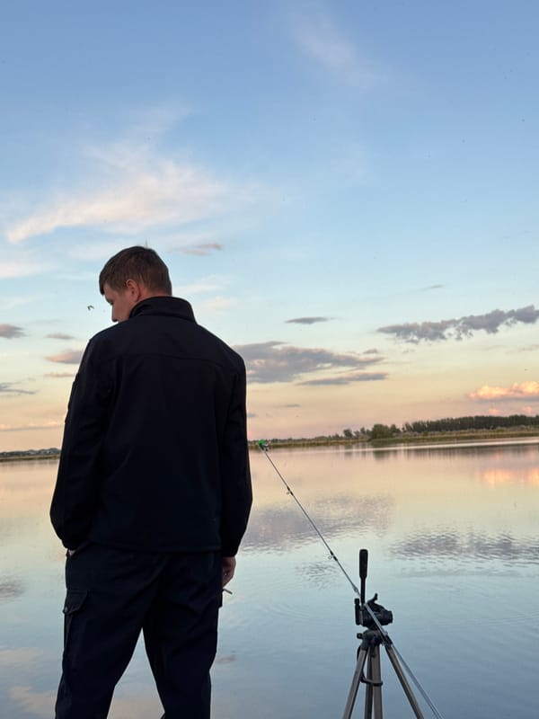 Angler enjoys peaceful fishing session on lake dock
