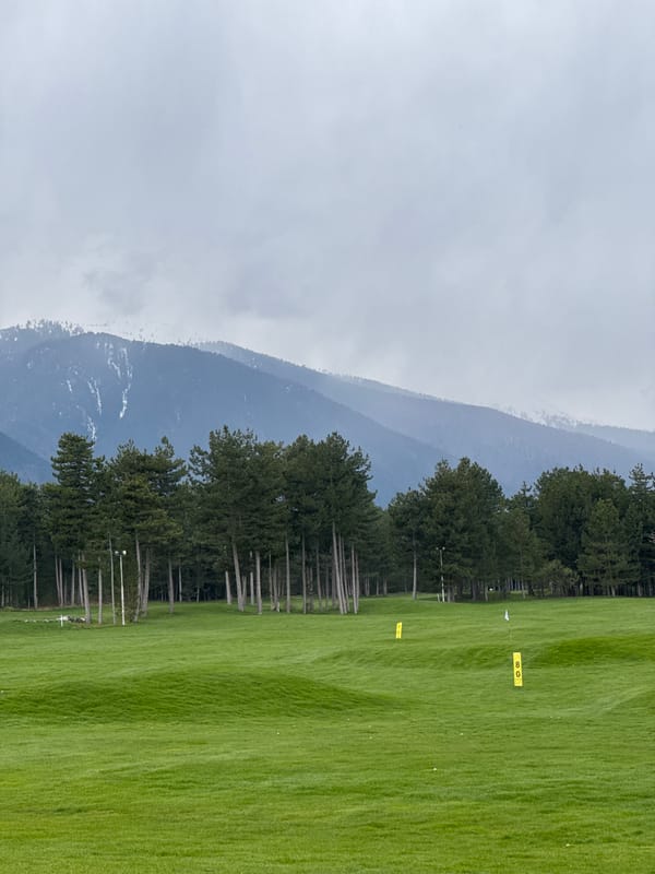Golf course photographed against mountain backdrop in Razlog, Bulgaria