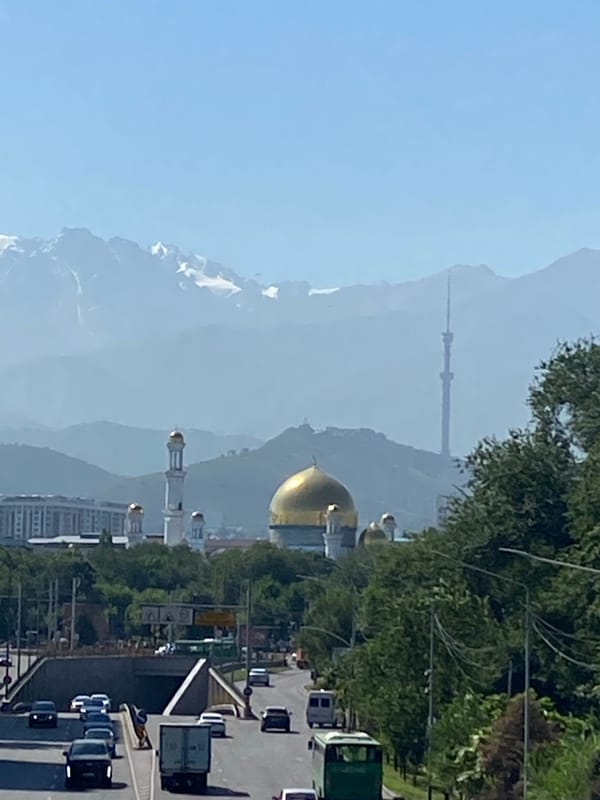 Almaty skyline with Tien Shan peaks and Central State Mosque