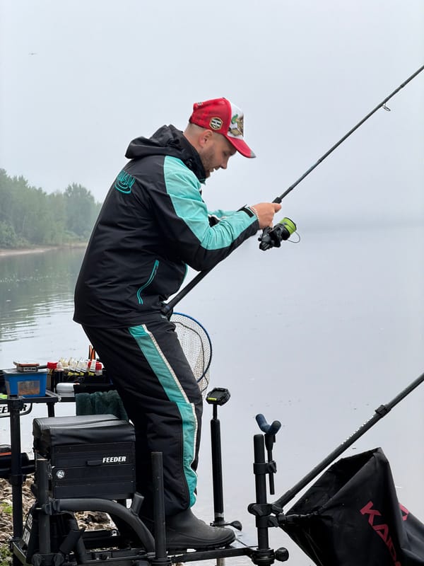 Early morning angler fishes calm waters in Noviy, Russia